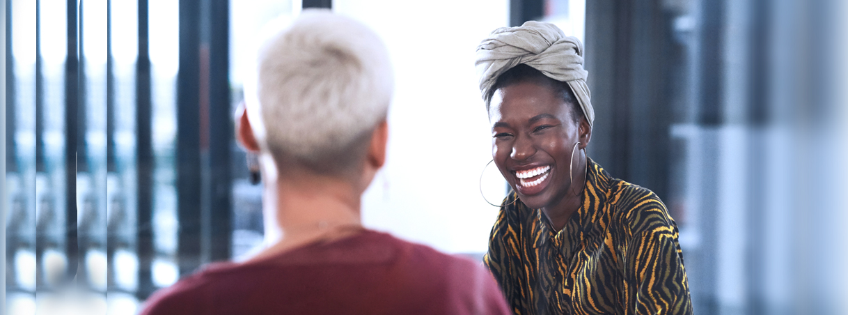 Employee_Corporate_AfricanAmerican_Female_Meeting_1218x452_SA